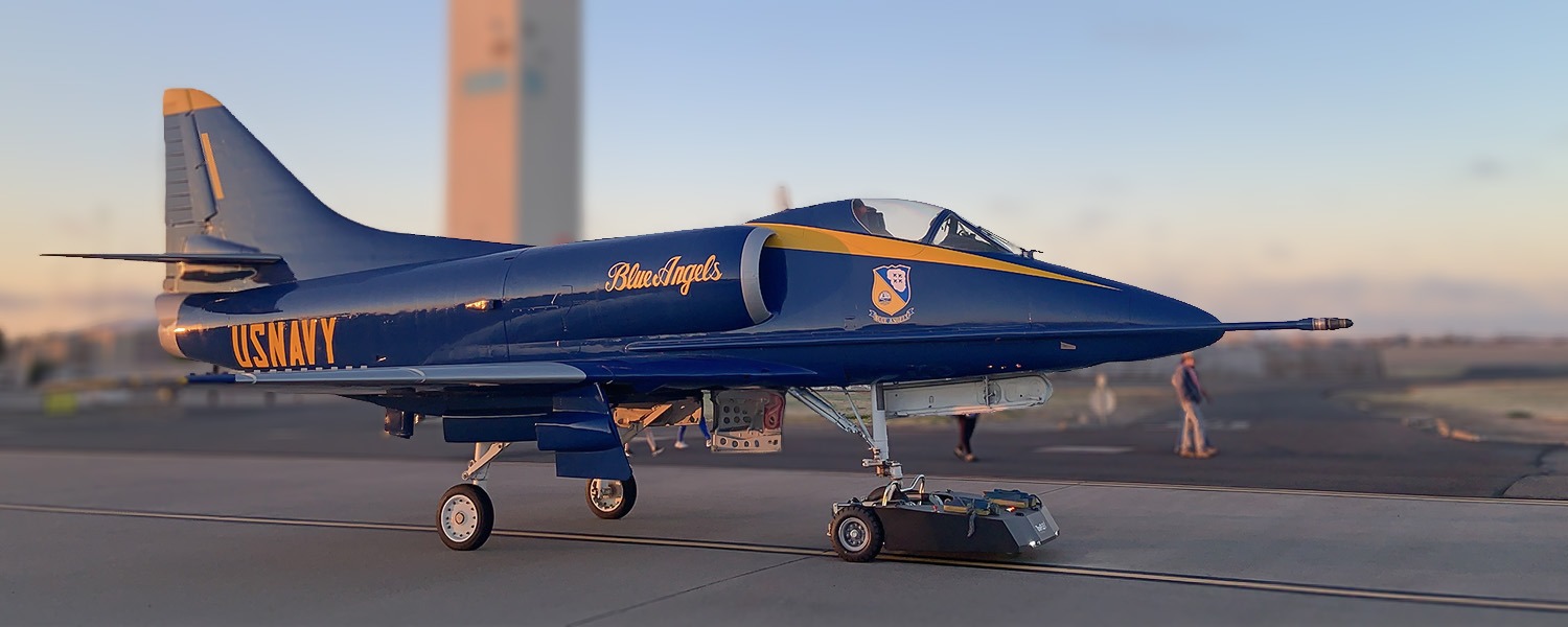 TowFLEXX TF4 Milspec aircraft tug towing a US Navy Blue Angels A-4F Skyhawk, showcasing its capability in providing efficient ground handling for military and naval aviation