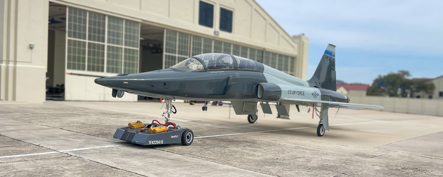 TowFLEXX TF4 Milspec aircraft tug efficiently towing a USAF T-38 Talon, demonstrating superior ground handling capabilities for military jets.