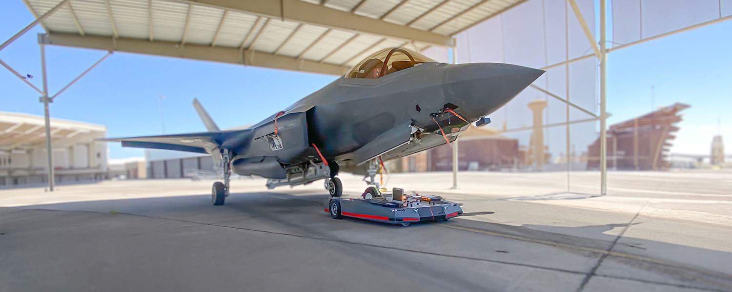 USAF F-35 jet being towed by the TowFLEXX TF5 MilSpec, illustrating cutting-edge ground handling technology in military aviation.